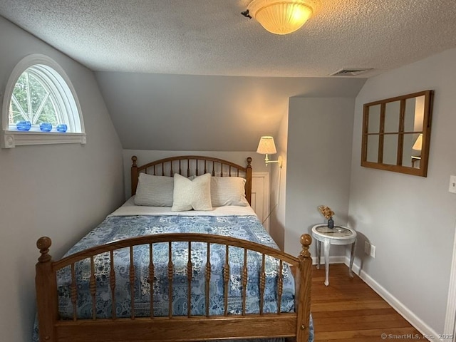 19 Hartford Ave, Old Saybrook, CT 06475 - bedroom featuring wood finished floors, lofted ceiling, and a textured ceiling