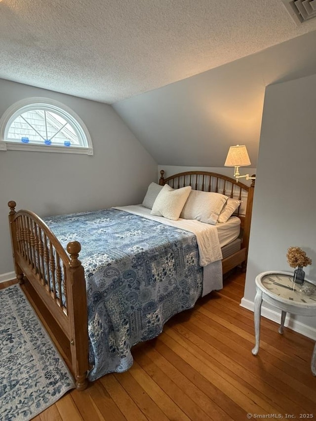 19 Hartford Ave, Old Saybrook, CT 06475 - bedroom with wood-type flooring, a textured ceiling, and vaulted ceiling