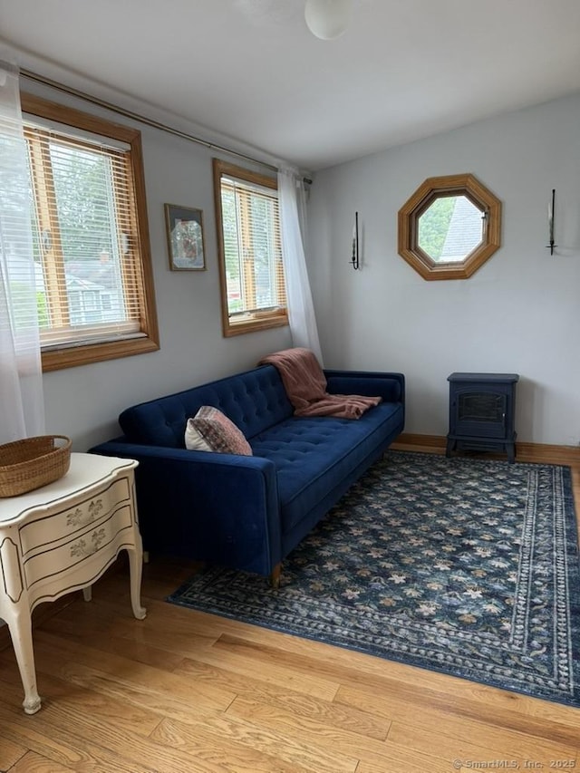 19 Hartford Ave, Old Saybrook, CT 06475 - living room featuring a wood stove, wood finished floors, and healthy amount of natural light