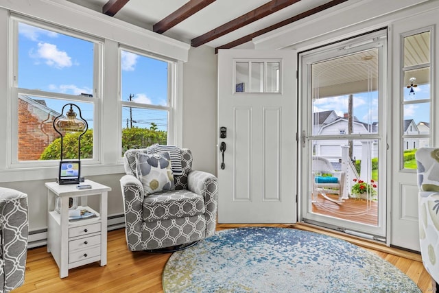 8 Fenbrook Rd, Old Saybrook, CT 06475 - living area with beamed ceiling, plenty of natural light, light wood-type flooring, baseboard heating, and a baseboard radiator