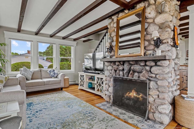 8 Fenbrook Rd, Old Saybrook, CT 06475 - living area with a fireplace, wood finished floors, plenty of natural light, beam ceiling, and a baseboard radiator