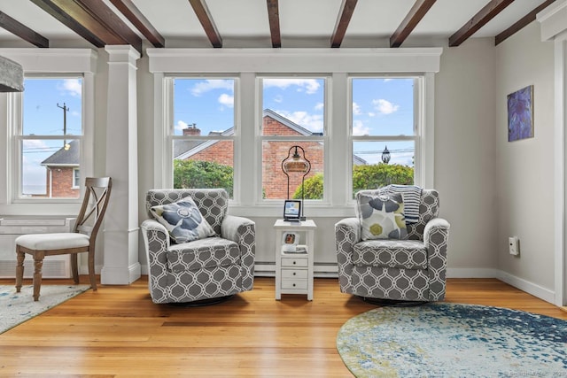 8 Fenbrook Rd, Old Saybrook, CT 06475 - sitting room with beam ceiling, plenty of natural light, light wood finished floors, and decorative columns
