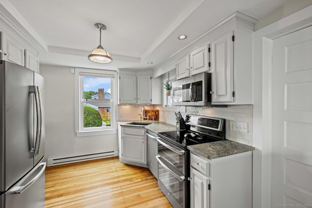 8 Fenbrook Rd, Old Saybrook, CT 06475 - kitchen with appliances with stainless steel finishes, a baseboard radiator, a raised ceiling, decorative backsplash, and recessed lighting
