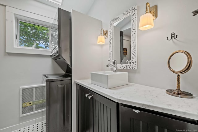 8 Fenbrook Rd, Old Saybrook, CT 06475 - bathroom featuring stacked washer / drying machine, heating unit, and double vanity
