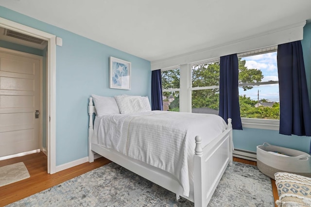 8 Fenbrook Rd, Old Saybrook, CT 06475 - bedroom with wood finished floors, multiple windows, and a baseboard radiator