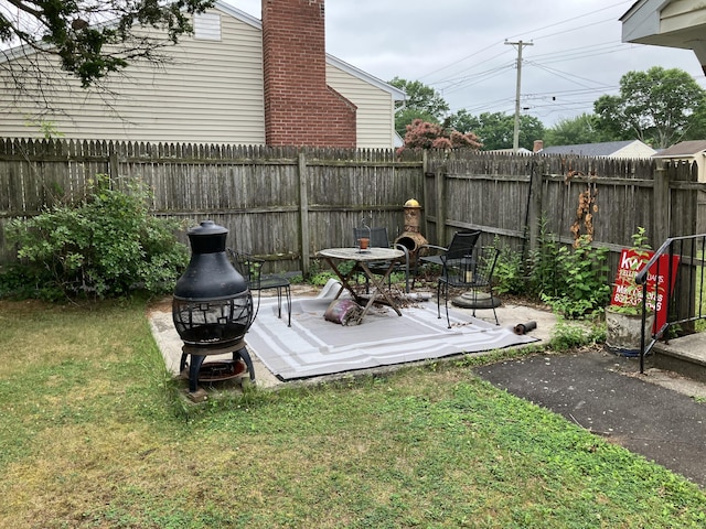74 Brussels Ave, Wethersfield, CT 06109 - fenced backyard featuring a fire pit