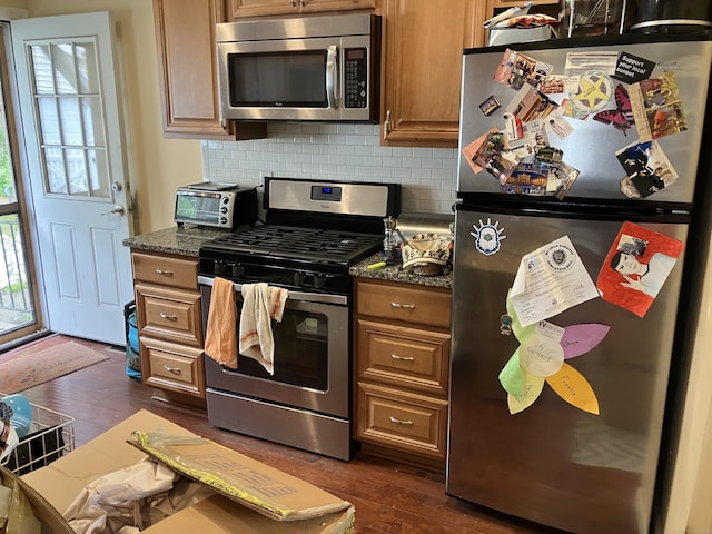 74 Brussels Ave, Wethersfield, CT 06109 - kitchen featuring stainless steel appliances, decorative backsplash, dark wood finished floors, and brown cabinets