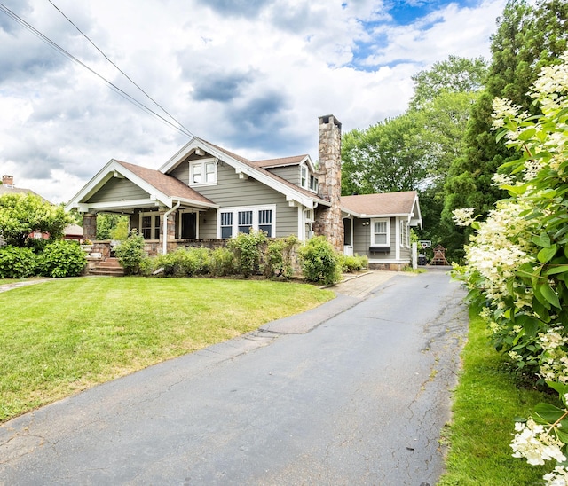 336 Main St, Wethersfield, CT 06109 - view of front of home featuring a porch, a chimney, a front lawn, and asphalt driveway
