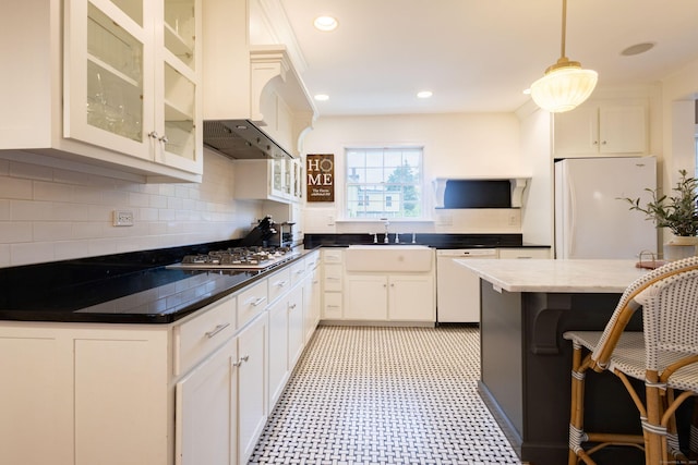 336 Main St, Wethersfield, CT 06109 - kitchen with white appliances, light flooring, glass insert cabinets, decorative light fixtures, and decorative backsplash