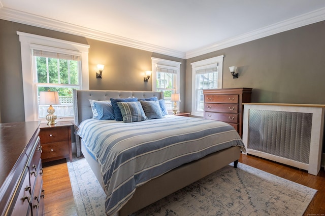 336 Main St, Wethersfield, CT 06109 - bedroom featuring radiator heating unit, multiple windows, ornamental molding, and light wood-style floors