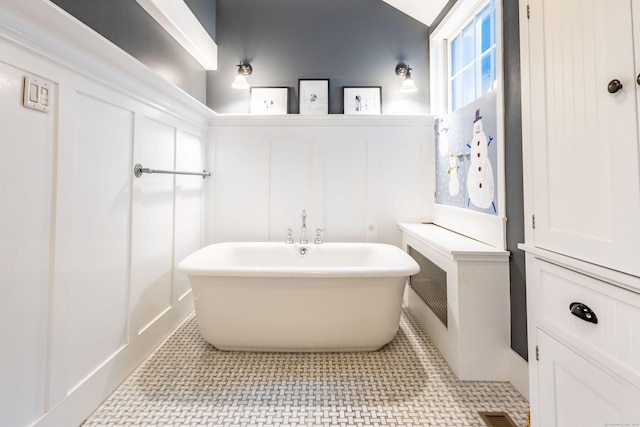 336 Main St, Wethersfield, CT 06109 - bathroom featuring a freestanding bath, a decorative wall, and a wainscoted wall