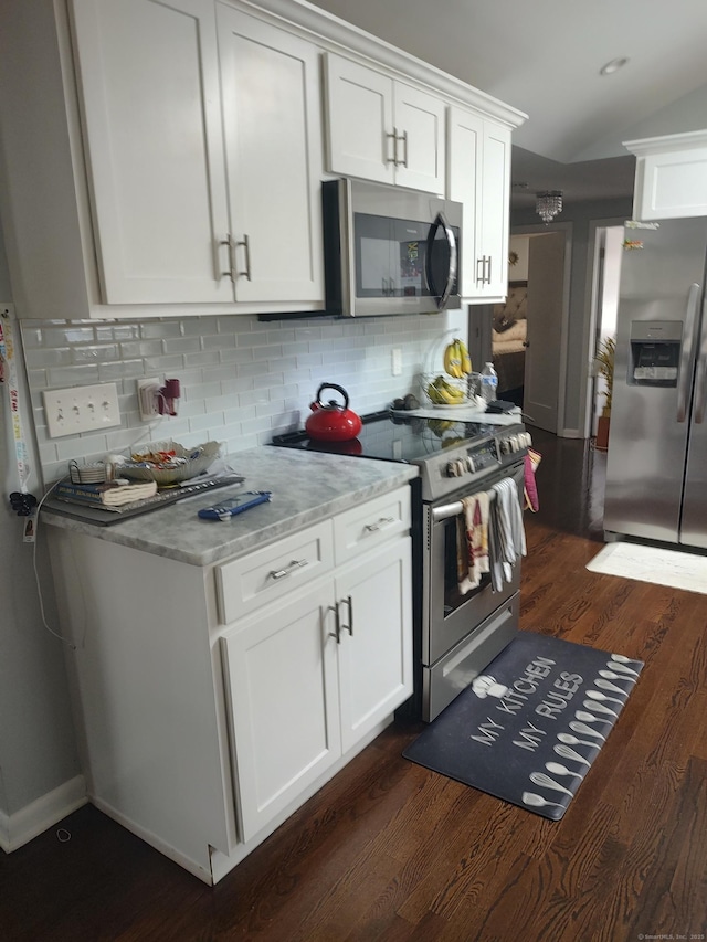 191 Dawson Ave, West Haven, CT 06516 - kitchen featuring appliances with stainless steel finishes, dark wood-style flooring, tasteful backsplash, and white cabinets