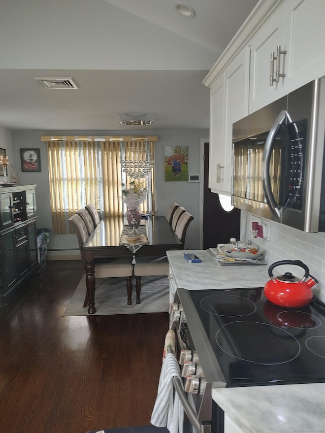 191 Dawson Ave, West Haven, CT 06516 - kitchen with appliances with stainless steel finishes, light countertops, dark wood finished floors, white cabinets, and lofted ceiling