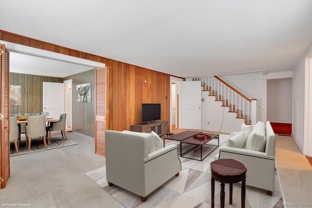 496 Mulberry St, Southington, CT 06479 - living room featuring stairway, wood walls, and light colored carpet