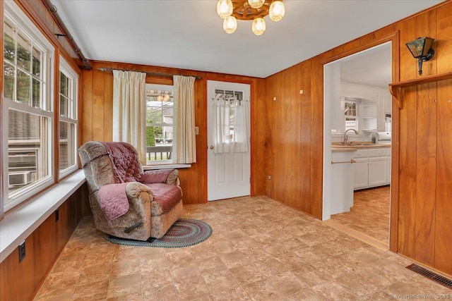 496 Mulberry St, Southington, CT 06479 - living area featuring a chandelier and wood walls