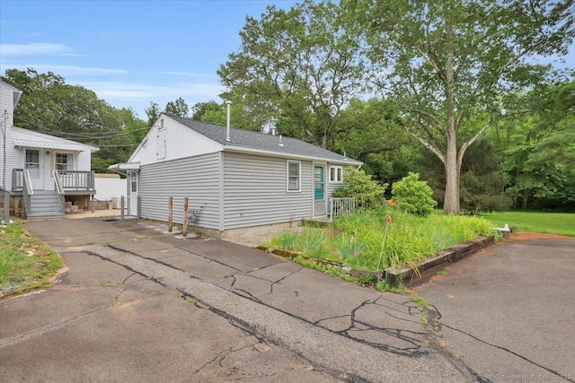 496 Mulberry St, Southington, CT 06479 - view of home's exterior with a shingled roof and asphalt driveway