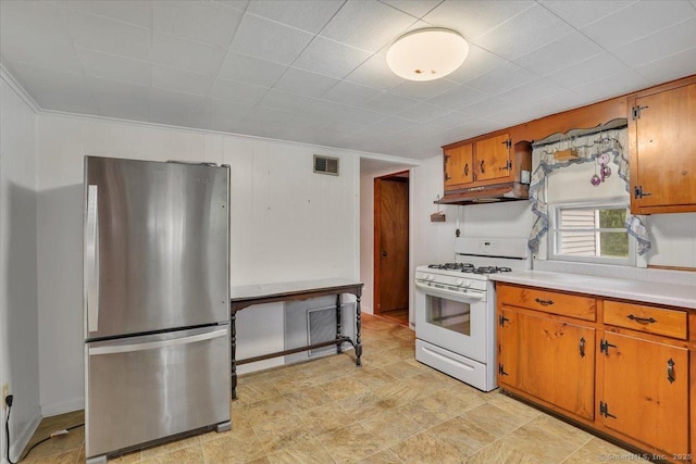 496 Mulberry St, Southington, CT 06479 - kitchen featuring freestanding refrigerator, white range with gas stovetop, brown cabinetry, light countertops, and under cabinet range hood