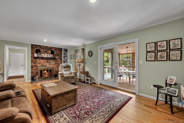 159 Woods Way Dr, Southbury, CT 06488 - living room with crown molding, a fireplace, light wood-type flooring, and recessed lighting
