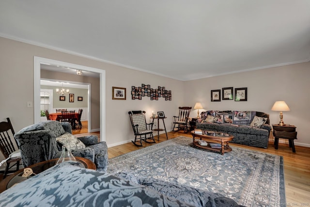 159 Woods Way Dr, Southbury, CT 06488 - living room featuring a chandelier, ornamental molding, and wood finished floors