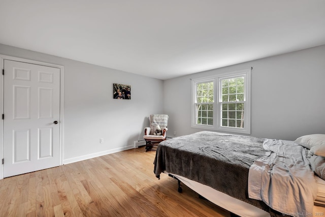 159 Woods Way Dr, Southbury, CT 06488 - bedroom with light wood-style flooring and a baseboard radiator