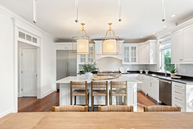 81 Birch Rd, Fairfield, CT 06824 - kitchen with dark wood-style floors, appliances with stainless steel finishes, decorative backsplash, a breakfast bar area, and recessed lighting