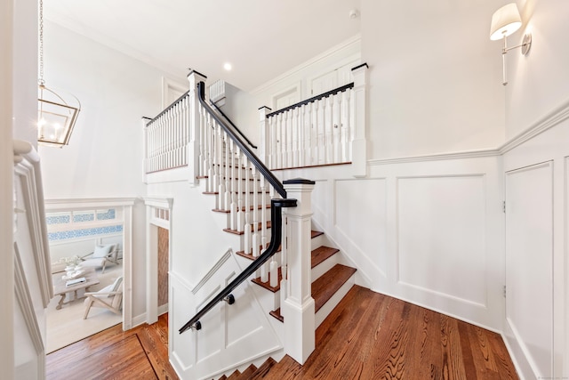 81 Birch Rd, Fairfield, CT 06824 - staircase featuring a decorative wall, wood finished floors, wainscoting, ornamental molding, and recessed lighting