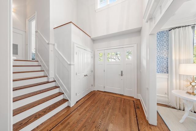 81 Birch Rd, Fairfield, CT 06824 - foyer entrance featuring plenty of natural light, light wood-style flooring, stairway, and a towering ceiling