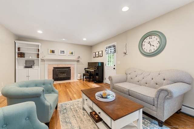 26 Philo Curtis Rd, Newtown, CT 06482 - living room featuring wood finished floors, a tiled fireplace, recessed lighting, and baseboard heating