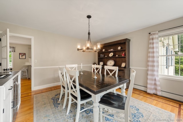 26 Philo Curtis Rd, Newtown, CT 06482 - dining space featuring light wood-style flooring, a chandelier, and a baseboard heating unit