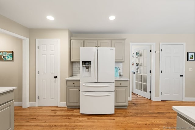 26 Philo Curtis Rd, Newtown, CT 06482 - kitchen with gray cabinetry, white fridge with ice dispenser, light wood finished floors, and recessed lighting
