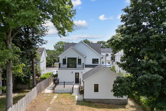 226 Ruane St, Fairfield, CT 06824 - rear view of property featuring roof with shingles and a wooden deck