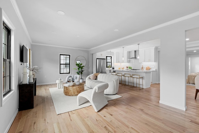 226 Ruane St, Fairfield, CT 06824 - living room with light wood finished floors, crown molding, and recessed lighting