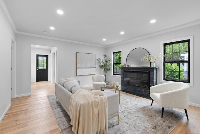 226 Ruane St, Fairfield, CT 06824 - living room featuring ornamental molding, plenty of natural light, a fireplace with flush hearth, recessed lighting, and light wood-style floors