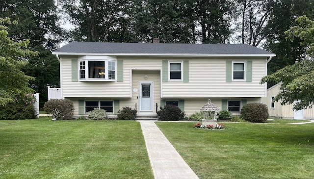 17 Stanley Dr, Plainfield, CT 06354 - bi-level home featuring a front lawn, a chimney, and roof with shingles
