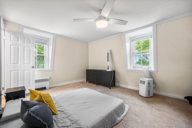22 Benjamin St, Norwich, CT 06360 - bedroom with radiator heating unit, multiple windows, carpet floors, and ceiling fan