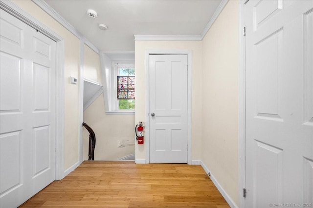22 Benjamin St, Norwich, CT 06360 - hall featuring light wood-style floors and crown molding
