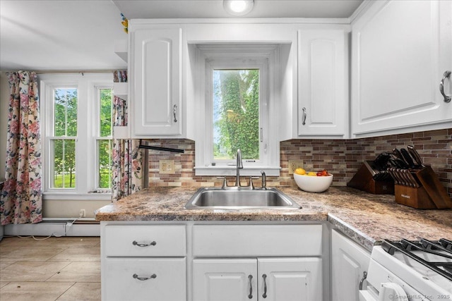 22 Benjamin St, Norwich, CT 06360 - kitchen featuring plenty of natural light, stove, backsplash, and white cabinetry