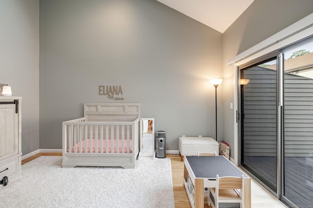 2289 Bedford St Unit F2, Stamford, CT 06905 - bedroom featuring light wood-style flooring, a nursery area, and high vaulted ceiling