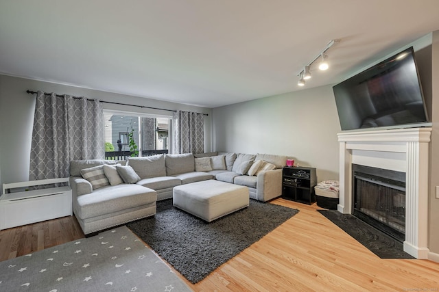 2289 Bedford St Unit F2, Stamford, CT 06905 - living area with wood finished floors, a fireplace with flush hearth, and track lighting