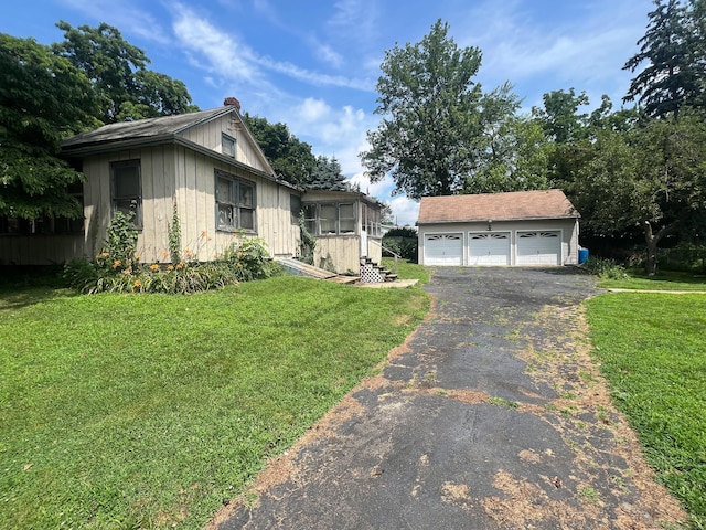 130 Wilkins Ave, Bridgeport, CT 06606 - view of front facade with an outbuilding, a detached garage, and a front lawn