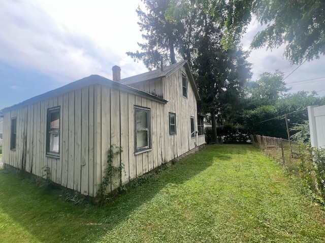 130 Wilkins Ave, Bridgeport, CT 06606 - view of home's exterior featuring a chimney and board and batten siding