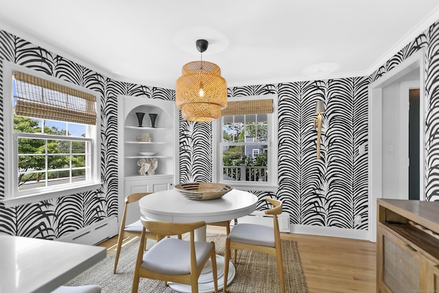 521 Lake Ave, Bridgeport, CT 06605 - dining room with wallpapered walls, light wood-style flooring, a baseboard radiator, and ornamental molding