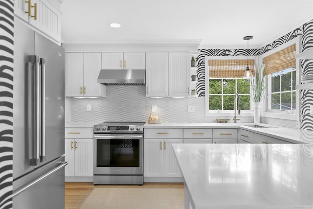 521 Lake Ave, Bridgeport, CT 06605 - kitchen with stainless steel appliances, light countertops, wall chimney exhaust hood, light wood-style flooring, and recessed lighting