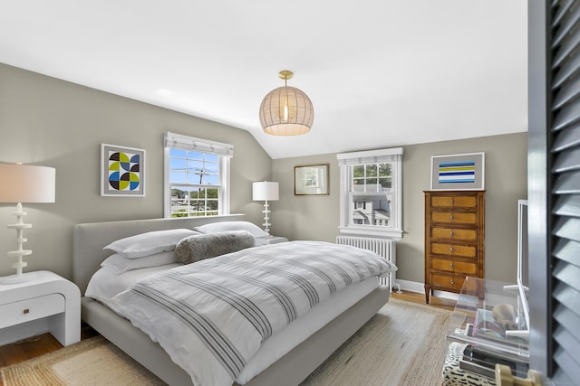 521 Lake Ave, Bridgeport, CT 06605 - bedroom featuring wood finished floors, radiator heating unit, lofted ceiling, and multiple windows