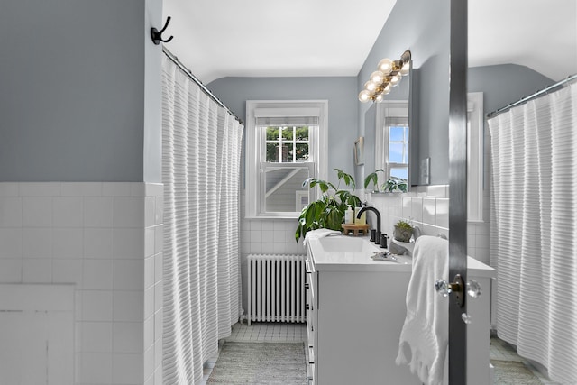521 Lake Ave, Bridgeport, CT 06605 - full bathroom featuring tile walls, radiator, vanity, lofted ceiling, and wainscoting