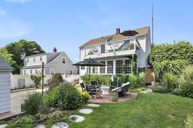 521 Lake Ave, Bridgeport, CT 06605 - back of property featuring a balcony, a chimney, a patio area, and roof with shingles