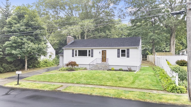 106 Lakeview Ave, West Haven, CT 06516 - view of front facade featuring a chimney, driveway, and roof with shingles