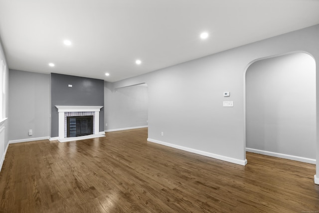 106 Lakeview Ave, West Haven, CT 06516 - unfurnished living room featuring arched walkways, recessed lighting, a fireplace, and dark wood-style floors