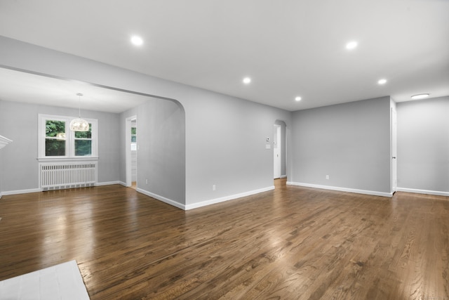 106 Lakeview Ave, West Haven, CT 06516 - spare room featuring arched walkways, radiator, dark wood-style floors, and recessed lighting