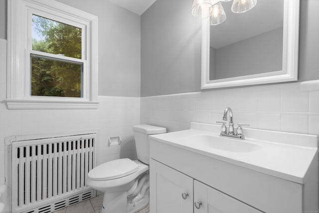 106 Lakeview Ave, West Haven, CT 06516 - bathroom featuring radiator, tile walls, vanity, tile patterned flooring, and wainscoting